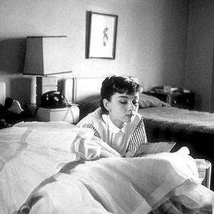 332338 Audrey Hepburn rests in her hotel room Chapman Park after a photo shoot at Paramount