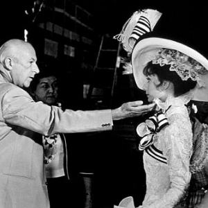 360441 My Fair Lady Production Designer Cecil Beaton checks Audrey Hepburns costume on the set