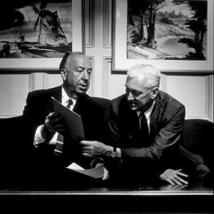 Alfred Hitchcock with writer Pete Martin in his office at Universal Studios, 1957.