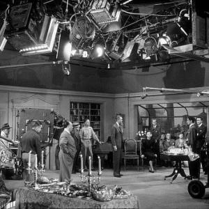 James Stewart, Alfred Hitchcock, and Cast on the set of 