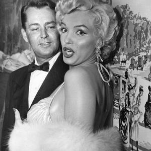 Marilyn Monroe with Alan Ladd after receiving actor & actress awards at the Photoplay Gold Metal Awards dinner, 1954.