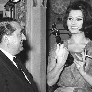 Sophia Loren shows Joseph Levine her Oscar in her home in Rome Italy c 1961