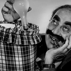 Groucho Marx holding a lightbulb for an advertisement, circa 1955. Modern silver gelatin, 14x11 unsgned, $600 © 1978 Paul Hesse MPTV