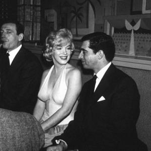 M. Monroe & Yves Montand at a party for