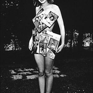 M Monroe as Norma Jean Baker covering herself with her magazine covers 1946
