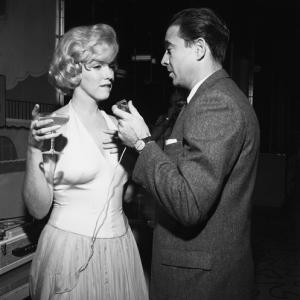Marilyn Monroe and Army Archerd at a party for 