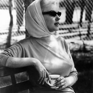 Marilyn Monroe sits in the Florida sun watching Joe Dimaggio in his new role as batting coach for the New York Yankees 1961