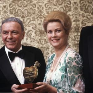 Grace Kelly presenting Humanitarian Award to Frank Sinatra Gregory Peck on right