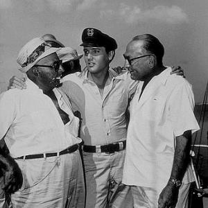 Elvis Presley, Norman Taurog (director), and Hal B. Wallis (producer) on location for 