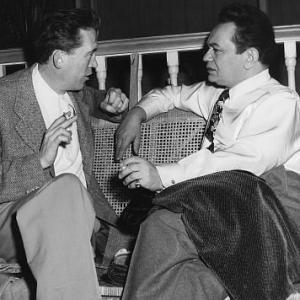 Edward G. Robinson with Director John Huston behind the scene of 