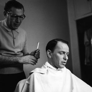 Frank Sinatra gettting a haircut circa 1960