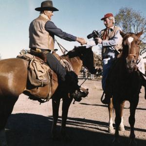 John Wayne and photographer David Sutton on the set of Chisum