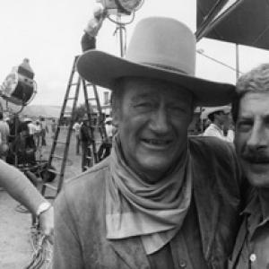 John Wayne and photographer David Sutton on the set of The Cowboys Michael Wayne at far left