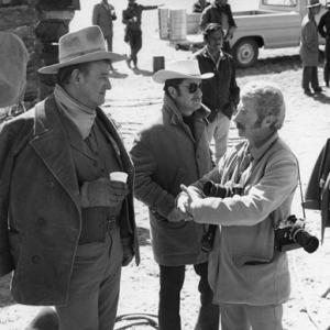 John Wayne and photographer David Sutton on the set of The Cowboys