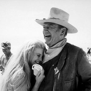 The Train Robbers AnnMargret and John Wayne during a break from filming 1973