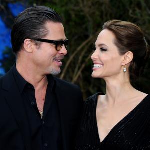 Brad Pitt and Angelina Jolie attend a private reception as costumes and props from Disneys Maleficent are exhibited in support of Great Ormond Street Hospital at Kensington Palace on May 8 2014 in London England