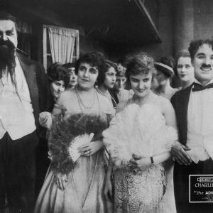 Still of Charles Chaplin, Eric Campbell, Marta Golden and Edna Purviance in The Adventurer (1917)