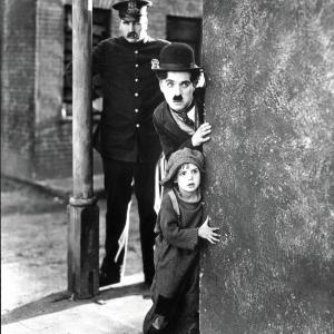 Still of Charles Chaplin and Jackie Coogan in The Kid 1921