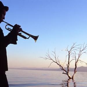 Tom Val Kilmer with his horn in silhouette at the Salton Sea