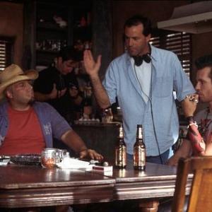 Director DJ Caruso standing discusses the scene at PoohBears table with Val Kilmer right and Vincent DOnofrio left