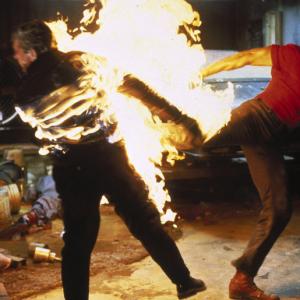 Wellman Anthony Santee (Dolph Lundgren) high-kicks a blazing henchman (Andy Armstrong) because that's the kind of guy he is, in Joshua Tree.