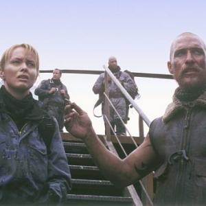 Van Zan (Matthew McConaughey, right), an American mercenary, with his pilot, Alex Jensen (Izabella Scorupco, left) arrives in Britain with the firepower to bring down the beasts.