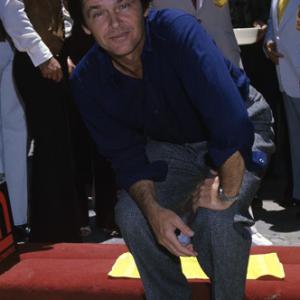 Jack Nicholson putting his hand and footprints at Graumans Chinese Theatre