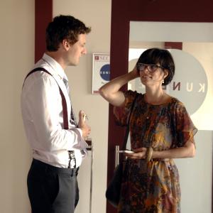 Still of Parker Posey and Callum Blue in And Now a Word from Our Sponsor (2013)