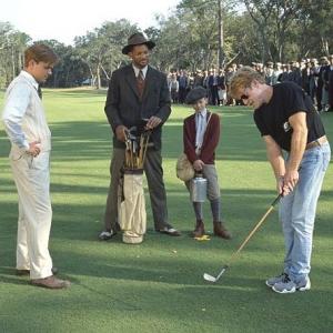 Director Robert Redford demonstrates a golf swing for his stars