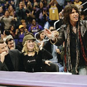 Chili Palmer JOHN TRAVOLTA Edie UMA THURMAN and Aerosmith frontman STEVEN TYLER take in a Lakers game courtside in MGM Pictures comedy BE COOL