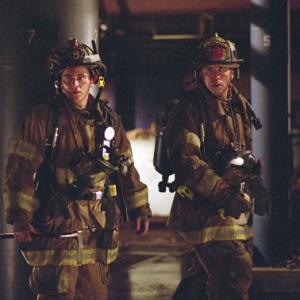 Still of John Travolta and Joaquin Phoenix in Ladder 49 (2004)