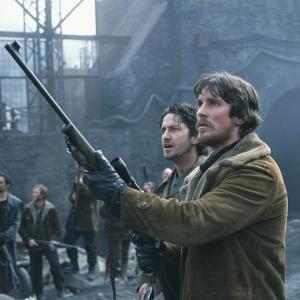 Quinn Christian Bale right and his righthand man Creedy Gerard Butler left stand guard over a castle that houses some of the last survivors on earth