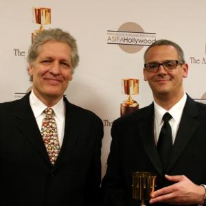Presenter Clancy Brown with Warner Bros. Animation president Sam Register, accepting the Winsor McCay award on behalf of Bruce Timm
