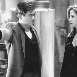 Still of Mira Sorvino and YunFat Chow in The Replacement Killers 1998