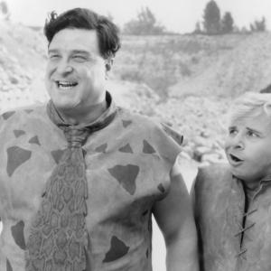 Still of John Goodman and Rick Moranis in The Flintstones 1994