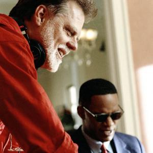 Director/producer/story writer TAYLOR HACKFORD and JAMIE FOXX (as American legend Ray Charles) on the set of the musical biographical drama, Ray.