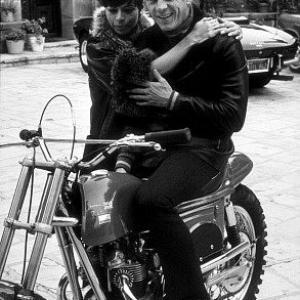 Steve McQueen on his Metisse motorcycle, at home in Beverly Hills with wife Neile C. 1970