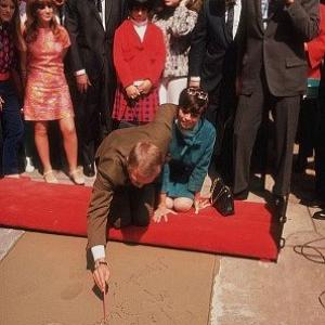 Steve McQueen getting footprints/handprints at Mann Chinese Theater with wife Neile