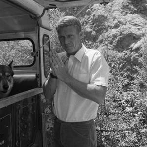Steve McQueen at home on Solar Drive in the Hollywood Hills with his dog and Land Rover circa 1963