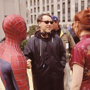 Director SAM RAIMI discusses a scene with stars TOBEY MAGUIRE as SpiderMan and KIRSTEN DUNST on the set of Columbia Pictures action adventure SPIDERMAN