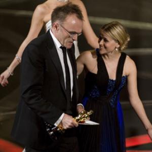 Academy Award®-winner Danny Boyle (left) with presenter Reese Witherspoon telecast at the 81st Academy Awards® are presented live on the ABC Television network from The Kodak Theatre in Hollywood, CA, Sunday, February 22, 2009.