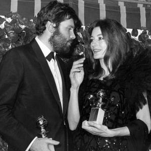 Anouk Aimee with husband Pierre Barouh holding her Golden Globe Award at the Cocoanut Groove, 1967.