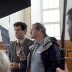 PIERCE BROSNAN discusses a scene with director BRUCE BERESFORD on the set.