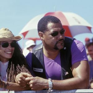 Queenie LISA BONET and Smoke LAURENCE FISHBURNE watch a race from the sidelines