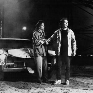 Still of Michael Keaton and Rae Dawn Chong in The Squeeze (1987)
