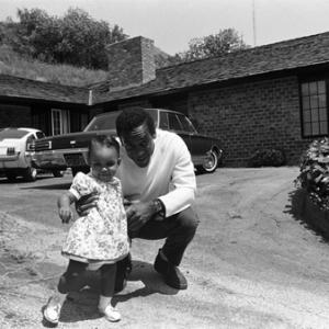 Bill Cosby at home with his daughter Erika (1966 Ford Shelby GT350 Mustang in background)