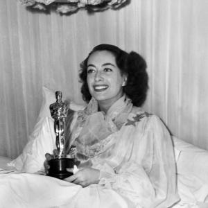 Best Actress Joan Crawford Mildred Pierce with her award at home awarded to her at the 18th Academy Awards