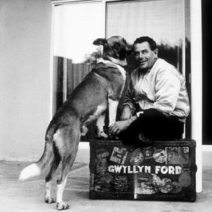 Glenn Ford with his pet dog at home 1958