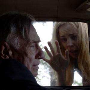 Kathy (MELISSA GEORGE) tries to get Father McNamara's (PHILIP BAKER HALL) help in THE AMITYVILLE HORROR.