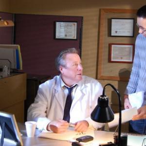 John Heard (starring as Dr. Alan Shearson) converses with director Russ Emanuel in P.J., a Russ Emanuel film.